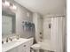 Bright bathroom featuring white marble tiled shower, modern fixtures and ample counter space at 15226 W 93Rd Ave, Arvada, CO 80007