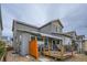 Rear exterior featuring a deck with awning and gray siding at 15226 W 93Rd Ave, Arvada, CO 80007