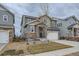 Two-story home featuring a stone accent entrance and a two-car garage at 15226 W 93Rd Ave, Arvada, CO 80007