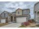 Charming two-story home with stone accents, attached garage, and landscaped front yard at 15226 W 93Rd Ave, Arvada, CO 80007