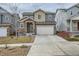 Charming two-story home with stone accents, attached garage, and easy-care landscaping at 15226 W 93Rd Ave, Arvada, CO 80007