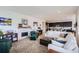 Open-concept living room with fireplace and access to the kitchen at 15226 W 93Rd Ave, Arvada, CO 80007