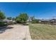 Spacious backyard with a concrete patio area and grassy lawn, offering ample outdoor space and a chain-link fence at 7111 Clermont St, Commerce City, CO 80022