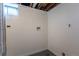 Basement area, clean and ready for customization, with visible utility connections and painted floor at 7111 Clermont St, Commerce City, CO 80022
