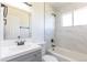 Bathroom with white marble style tiled walls, sleek sink, and modern fixtures at 7111 Clermont St, Commerce City, CO 80022