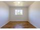 Bright bedroom with ceiling fan, hardwood floors, and a window offering natural light at 7111 Clermont St, Commerce City, CO 80022