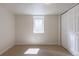 Bright bedroom with a carpeted floor, single window with closed blinds and a closet with sliding doors at 7111 Clermont St, Commerce City, CO 80022