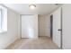 This bedroom features neutral colored walls, carpeted flooring, a window and a closet with sliding doors at 7111 Clermont St, Commerce City, CO 80022