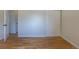Bedroom with wood floors, neutral paint and sliding closet doors at 7111 Clermont St, Commerce City, CO 80022