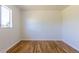 Bright bedroom features hardwood floors and a window, providing natural light at 7111 Clermont St, Commerce City, CO 80022