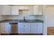 This kitchen features stainless steel appliances, white cabinets and granite countertops at 7111 Clermont St, Commerce City, CO 80022