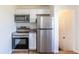 Updated kitchen features modern stainless steel appliances, white cabinets and granite countertops at 7111 Clermont St, Commerce City, CO 80022