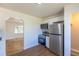 Updated kitchen features stainless steel appliances, white cabinets and granite countertops at 7111 Clermont St, Commerce City, CO 80022