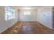 Spacious, bright living room features refinished hardwood floors and neutral paint at 7111 Clermont St, Commerce City, CO 80022