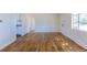 Living room with hardwood floors, neutral paint and updated doors and trim at 7111 Clermont St, Commerce City, CO 80022