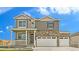 Charming two-story home featuring a stone facade, neutral siding, a welcoming porch, and a three-car garage at 226 Chardon Ave, Brighton, CO 80601