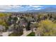 Wide aerial shot of property highlighting neighborhood, mature trees and mountain views at 851 Racquet Ln, Boulder, CO 80303