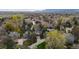Wide aerial shot of property highlighting neighborhood, mature trees, and manicured lawns at 851 Racquet Ln, Boulder, CO 80303