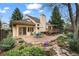 Charming backyard patio area featuring a brick patio, mature landscaping, and outdoor furniture at 851 Racquet Ln, Boulder, CO 80303