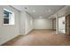 Spacious finished basement with neutral carpet, updated recessed lighting, and a bonus room through french doors at 851 Racquet Ln, Boulder, CO 80303