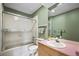 Outdated bathroom featuring green walls, pink countertop, and shower-tub combo at 851 Racquet Ln, Boulder, CO 80303