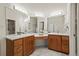 Bright bathroom features marble floors, & vanities, and a large mirror at 851 Racquet Ln, Boulder, CO 80303