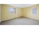 Empty bedroom with neutral carpet and two windows at 851 Racquet Ln, Boulder, CO 80303