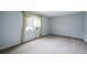 Empty bedroom with neutral carpet and a large window with curtains at 851 Racquet Ln, Boulder, CO 80303