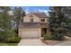 Charming two-story home featuring a two-car garage, neutral paint, and mature trees in a well-maintained yard at 851 Racquet Ln, Boulder, CO 80303