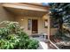 Inviting front porch with a wood door, decorative plants, and charming details enhance the curb appeal at 851 Racquet Ln, Boulder, CO 80303