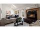 Cozy living room featuring a fireplace, skylights and hardwood floors, creating a comfortable and inviting space at 851 Racquet Ln, Boulder, CO 80303