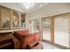 Bright sunroom area containing a private hot tub with wooden deck at 851 Racquet Ln, Boulder, CO 80303