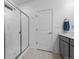 Bathroom featuring glass shower with gray vanity and tile flooring at 452 S Norfolk Ct, Aurora, CO 80017