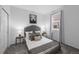 Cozy bedroom featuring a tufted headboard, neutral bedding, carpet, and natural light at 452 S Norfolk Ct, Aurora, CO 80017