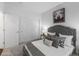Cozy bedroom featuring a tufted headboard, neutral bedding, carpet, and natural light at 452 S Norfolk Ct, Aurora, CO 80017