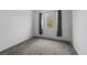 Empty bedroom featuring carpet, white walls, a window and minimal decor at 452 S Norfolk Ct, Aurora, CO 80017