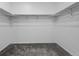 Walk-in closet with carpet flooring and clothing rods for ample storage at 452 S Norfolk Ct, Aurora, CO 80017