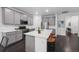 Spacious kitchen boasts stainless steel appliances, island with seating, and modern finishes at 452 S Norfolk Ct, Aurora, CO 80017