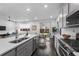 Open concept kitchen with island, stainless appliances, and seamless flow to living spaces at 452 S Norfolk Ct, Aurora, CO 80017