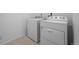 Bright laundry area features full-size, white washer and dryer at 452 S Norfolk Ct, Aurora, CO 80017
