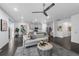 Open-concept living room featuring a ceiling fan, modern gray decor and dark hardwood floors at 452 S Norfolk Ct, Aurora, CO 80017