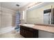 Standard bathroom with a vanity sink, white ceramic tile, and a shower-tub combo with a blue patterned shower curtain at 5721 W 92Nd Ave # 96, Westminster, CO 80031