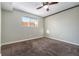 A standard bedroom with a ceiling fan, neutral walls, carpet, and a window allowing for natural light at 5721 W 92Nd Ave # 96, Westminster, CO 80031