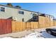 Exterior view from street showing fenced backyard, access stairs, AC Unit and building facade at 5721 W 92Nd Ave # 96, Westminster, CO 80031