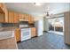 Functional kitchen featuring neutral tile flooring, modern appliances, and a sliding glass door to an outdoor patio at 5721 W 92Nd Ave # 96, Westminster, CO 80031