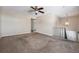 Bright living room featuring neutral walls, plush carpeting, ceiling fan, and staircase access at 5721 W 92Nd Ave # 96, Westminster, CO 80031