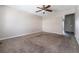 Spacious living room features neutral carpet, walls, ceiling fan and transition to another area with tiled floors at 5721 W 92Nd Ave # 96, Westminster, CO 80031