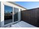 A quaint patio enclosed by a dark brown fence, with sliding glass doors leading to the interior space at 5721 W 92Nd Ave # 96, Westminster, CO 80031