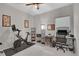 Bedroom features a stationary bike, neutral walls, a ceiling fan, and natural light from the window at 239 Chipeta Way, Lochbuie, CO 80603