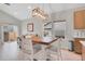 Bright dining area features stylish light fixture, wood table with seating for four, and adjacent living space at 239 Chipeta Way, Lochbuie, CO 80603